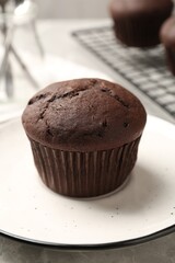 Delicious fresh chocolate cupcake on table, closeup