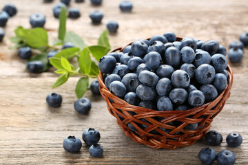 Tasty fresh blueberries on wooden table, closeup