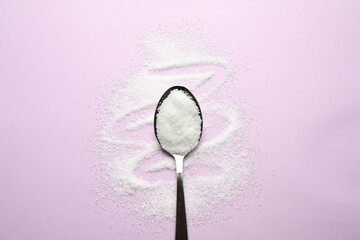 Granulated sugar and spoon on lilac background, flat lay