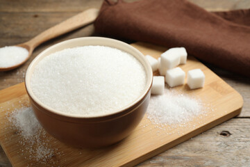 Granulated sugar in bowl on wooden table