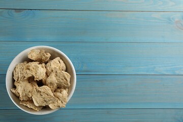 Dried soy meat on light blue wooden table, top view. Space for text