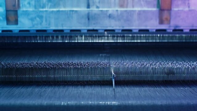 Weaving loom industrial textile production at work. close up, slow motion. 4K .3