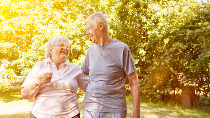 Laughing couple of seniors go for a walk together