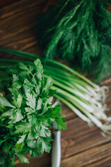 Fototapeta premium fresh green dill and parsley on wooden table