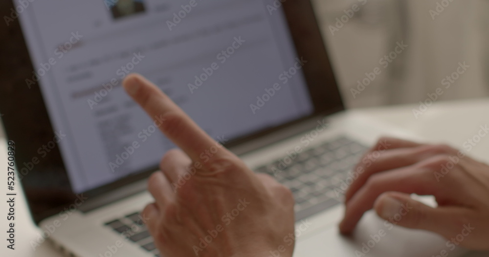 Fototapete man's hands use laptop keyboard in bokeh. he presses the buttons, uses the touchpad to control the a