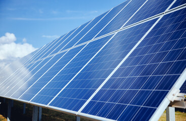 Obraz premium Set of solar panels mounted on roof of building. Renewable energy eco concept