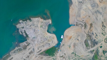 Aerial view Mangla Lake or river drone shot, Boat or ship standing at riverbank or lake shore with people swimming, pakistani or indian or south asian drone shot video 