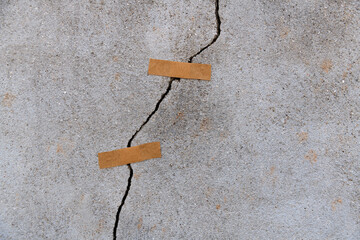 Cracked concrete wall with adhesives