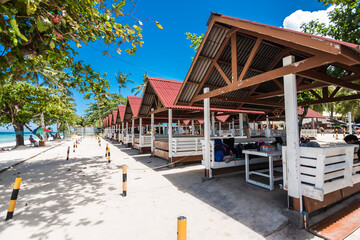 Panglao, Bohol, Philippines - Simple cottages with corrugated roofs line Dumaluan Beach.