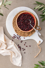 Red dry raw beans in a bowl on a kitchen countertop. Cooking Healthy Food. Top-view.