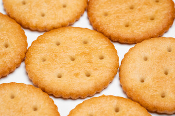 Healthy whole wheat cracker on white background. Stack of Saltine crackers isolated on white background. Round crackers.