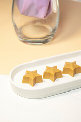 Star shaped handmade chocolate on a white plate.
