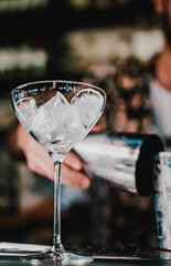Ice cube in an empty glass on a bar counter in bar or pub