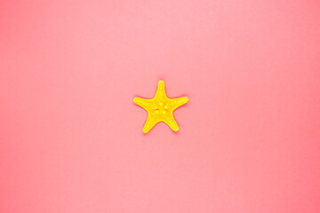 Beautiful decorative starfish on a red background. Close up.