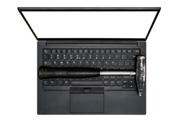 Top view of hammer placed on modern laptop keyboard