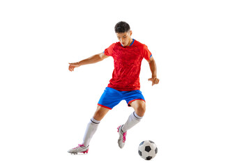 Portrait of young man, professional football player in motion, dribbling, training isolated over white studio background