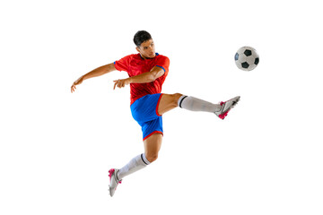 Fototapeta na wymiar Portrait of young man in uniform, professional football player kicking ball in a jump isolated over white studio background.