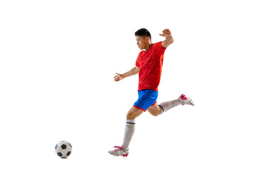 Fototapeta na wymiar Dynamic portrait of young man, professional football player in motion, training, dribbling ball isolated over white studio background