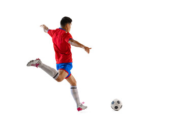 Fototapeta na wymiar Dynamic portrait of young man, professional football player in motion, training, dribbling ball isolated over white studio background