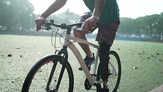 A disabled amputee cyclist riding bicycle with prosthetic leg