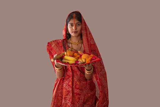 woman from Bihar offers prayers to the  sun  in the  early morning hours   during  Chhath Puja festival