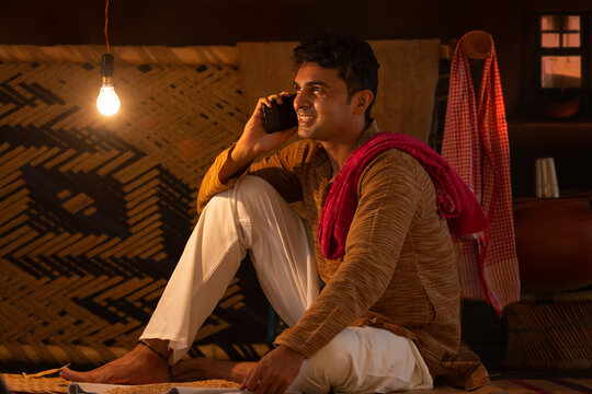Portrait of Bihar man talking on mobile phone at home