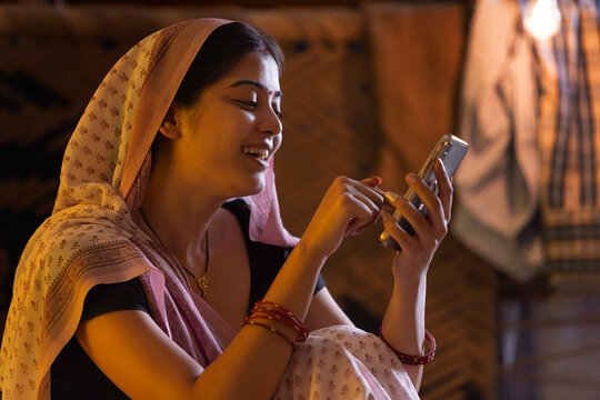 Bihar woman using mobile phone at home