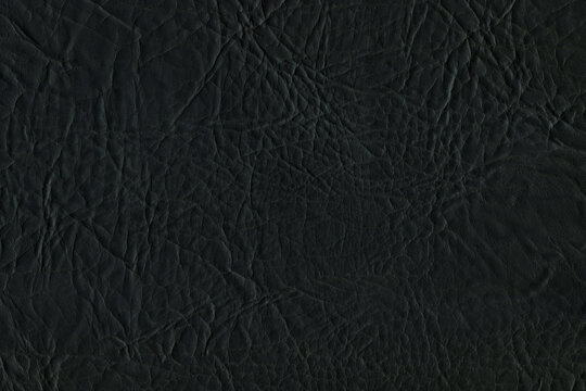 Black bright macro photo of texture of the genuine faux vegan leather. Fashion pattern and background. Leather with embossing. © artistmef