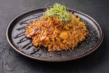 chinese fried rice with chicken on black plate