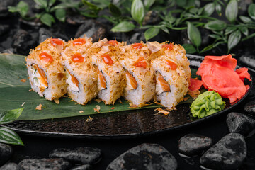 Closeup of sushi rolls on black plate