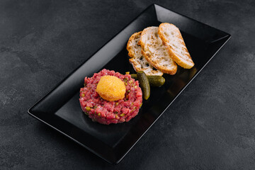 Beef tartar with salted cucumbers and grilled bread