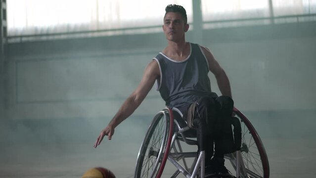 A disabled athlete in wheelchair playing basketball. Handicapped