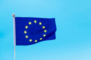 European Union flag waving on blue background