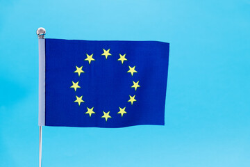 European Union flag waving on blue background