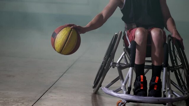 A disabled athlete in wheelchair playing basketball