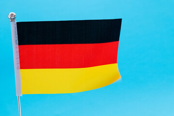 German flag waving on blue background