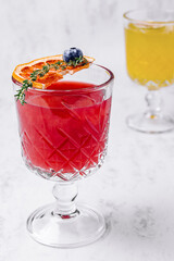 Blood orange margarita cocktail with ice and thyme
