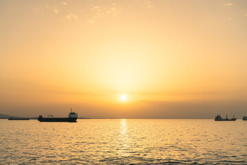 Sunset view at the sea with ship silhouettes.. 