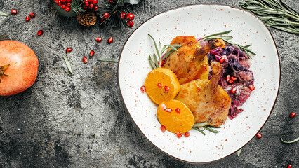 roast duck leg red cabbage on a dark background. Long banner format. top view