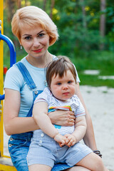 beautiful girl with children on a children's playground