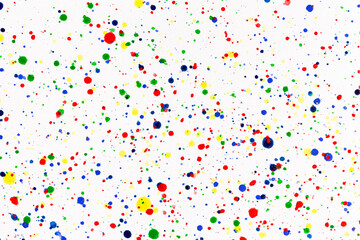 Paint splatters on bright material. Watercolor on white paper.