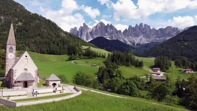 Relaxing drone view of St Maddalena in green Vall de Funes, Dolomites