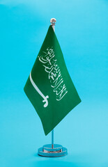 Saudi Arabia table flag on blue background