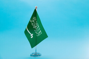 Saudi Arabia table flag on blue background