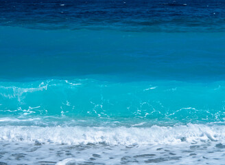 Beautiful foam waves on a sunny day in the Aegean Sea on the island in Greece