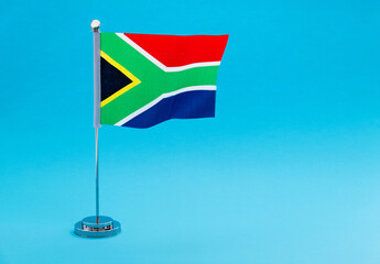 Naklejka premium South Africa table flag waving on blue background