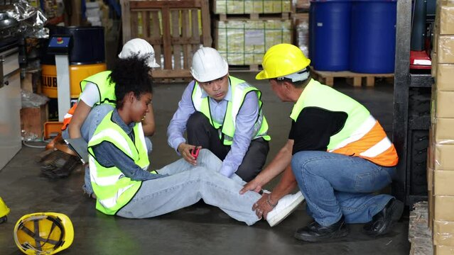 First Aid and safety first concept. Warehouse black african femal worker lying down on floor after accident in warehouse factory. Health insurance emergency accident