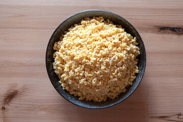 Soaked split mung beans in ceramic bowl on table, Top view