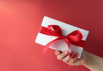 Top view of female hands holding present box package flat lay background copy space for design.