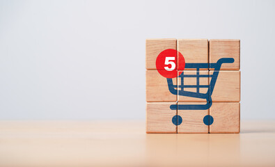 Notification number on shopping trolley cart icon print screen on wooden cube block for alarming of...